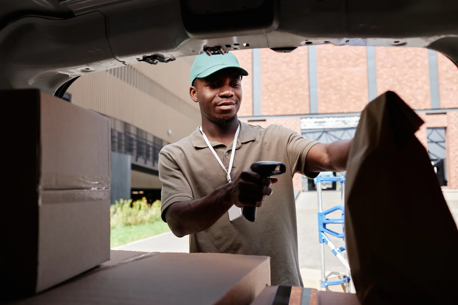 Delivery worker scanning packages inside a delivery van