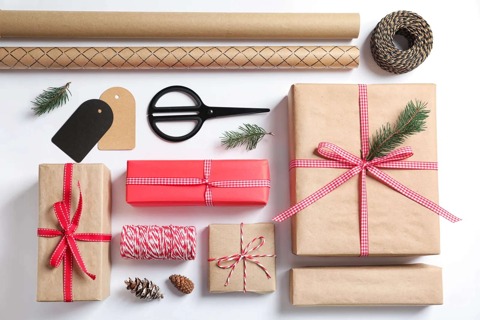 Christmas wrapping paper, ribbon, tags, scissors, and wrapped gifts
